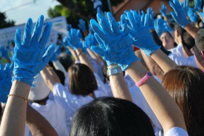 Personas con guantes con las manos levantadas