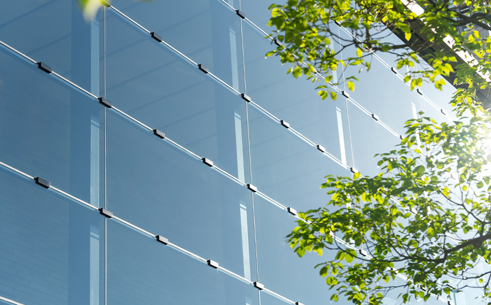 Fachada empresa usa tecnología sostenible árbol